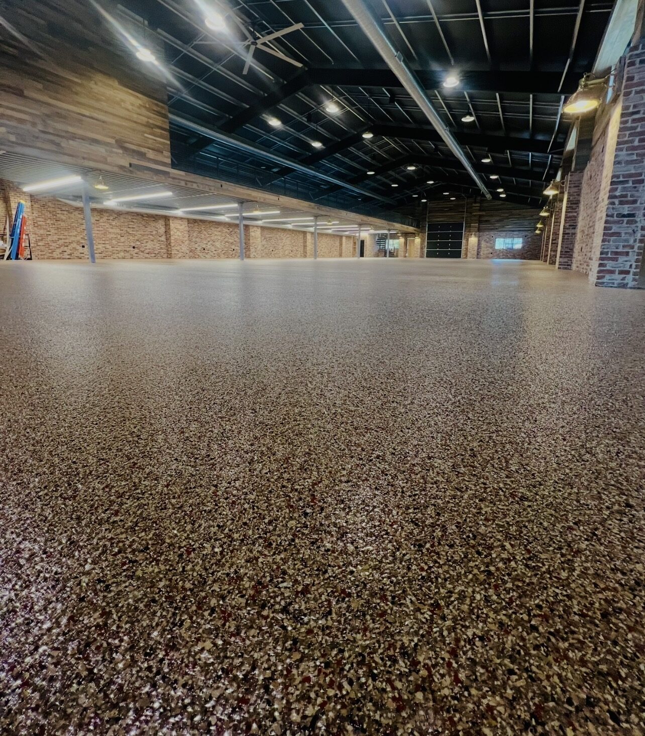 Decorative epoxy floor with a flowing metallic pattern